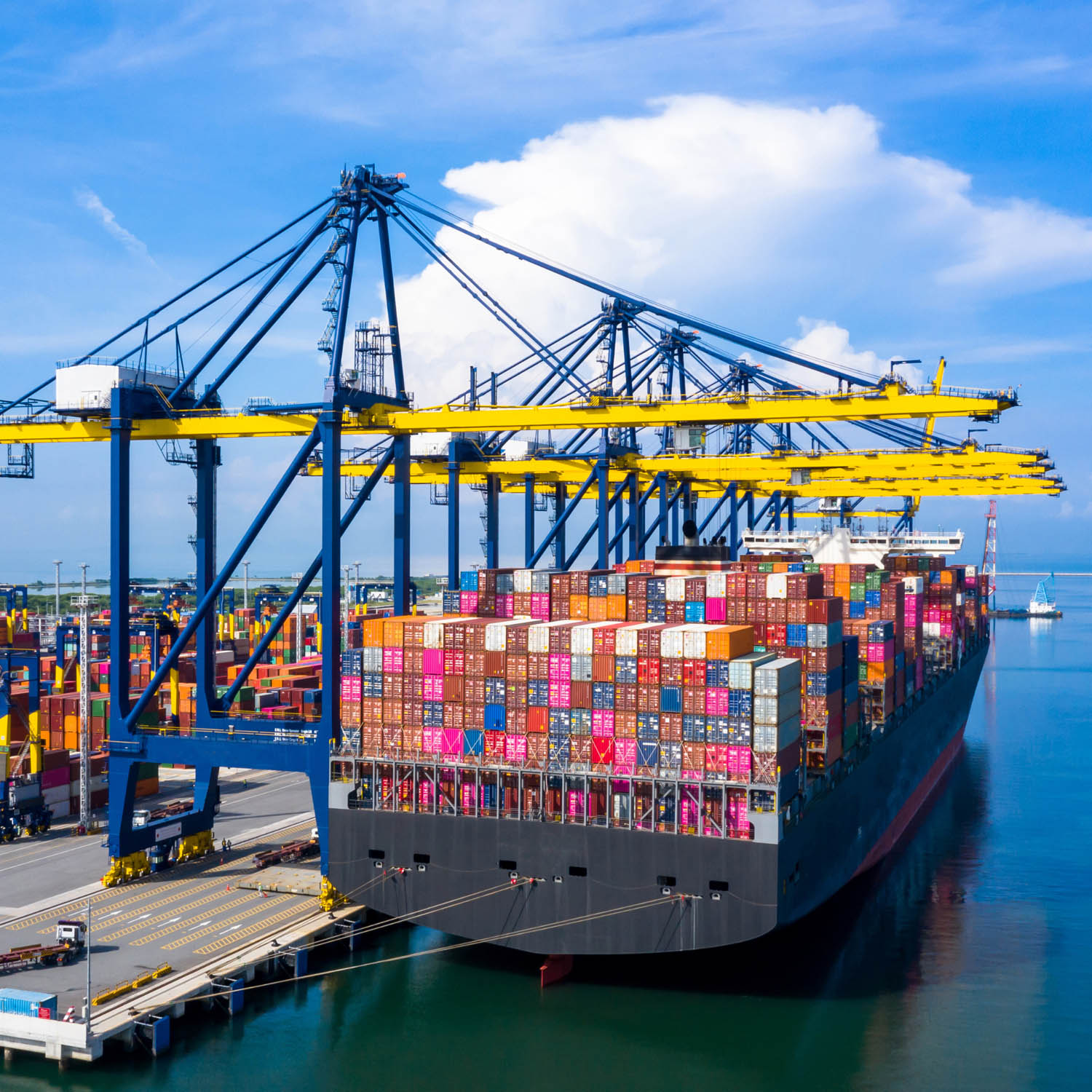 Cargo ship being loaded at a dock